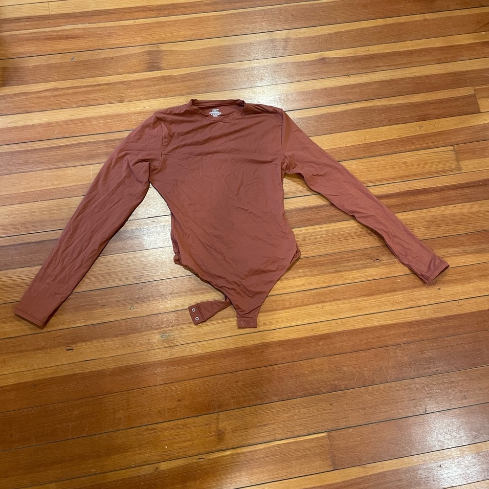 Skims rust colored bodysuit. Size large.